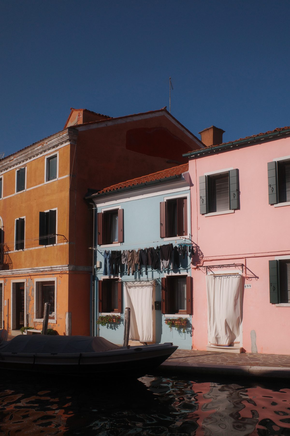 Laundry in front of a pink house