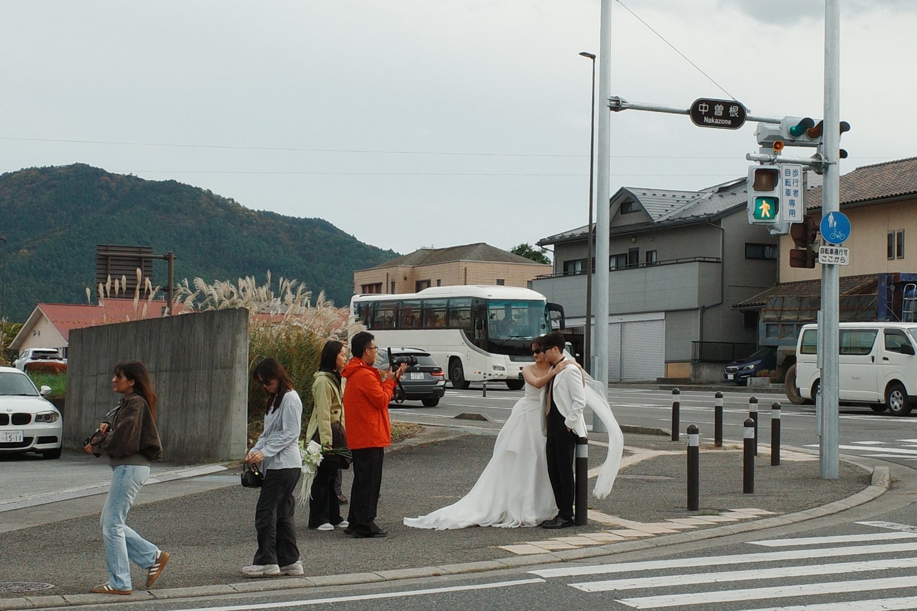 A wedding couple crossing the street