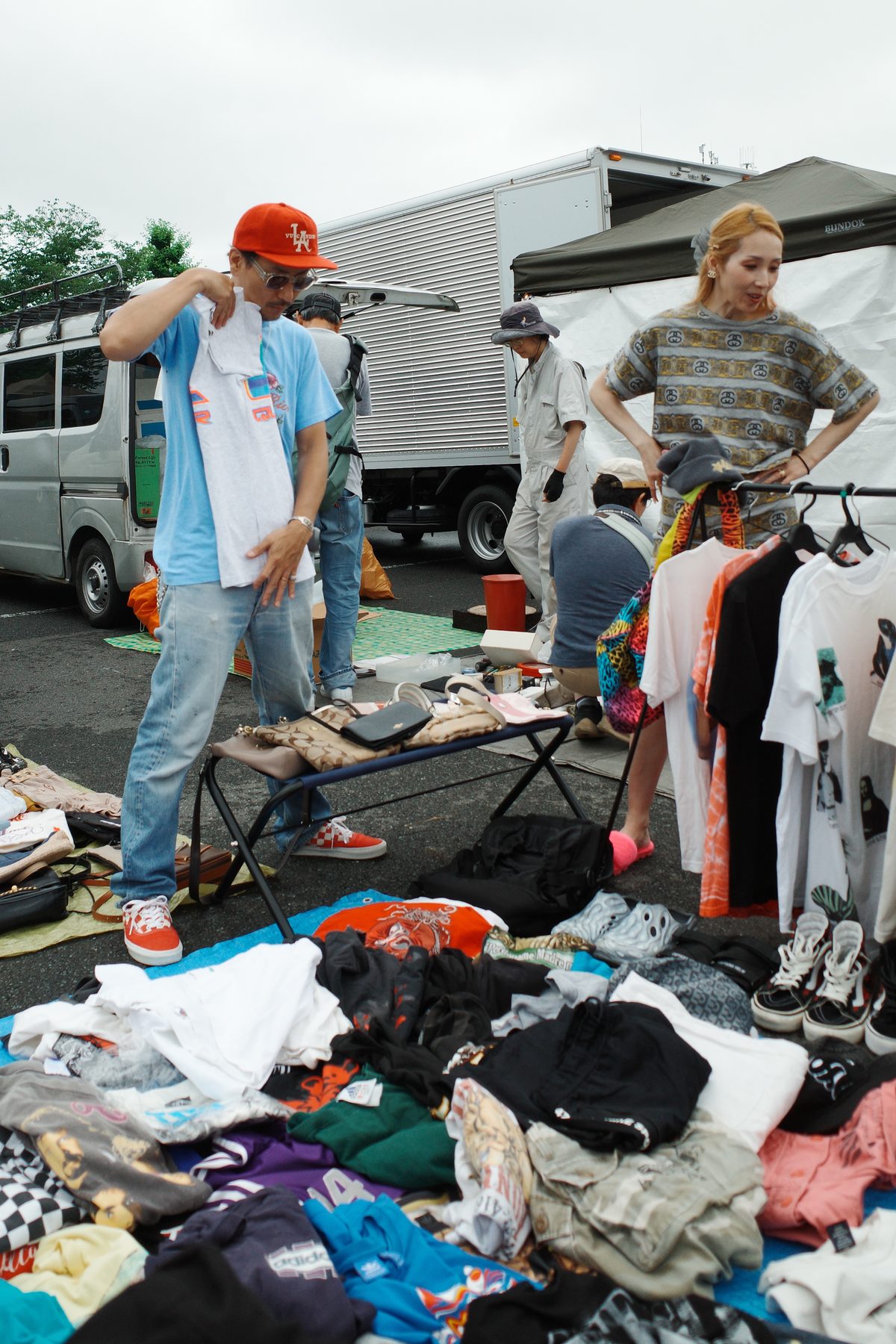 A man holding up a T-shirt