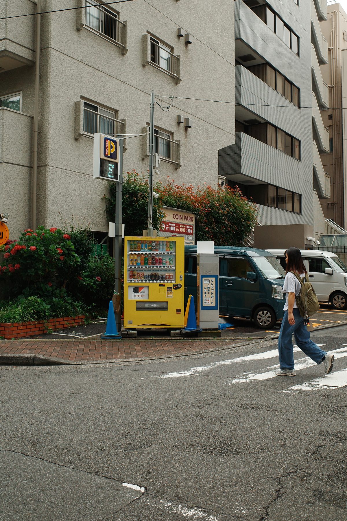 A yellow vending machine on a corner