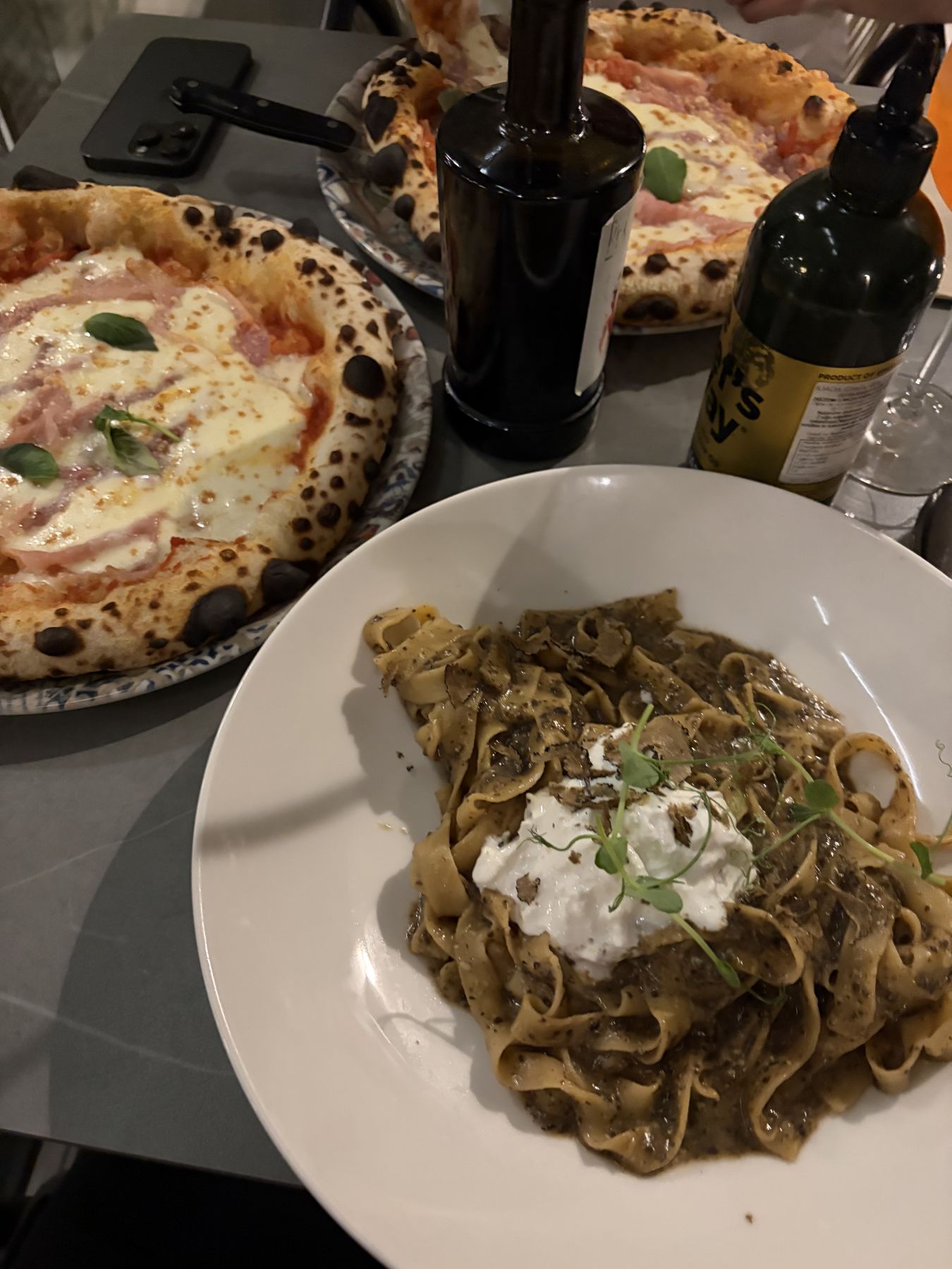 Truffle pasta with burratina and pizzas at REX Tiskarna