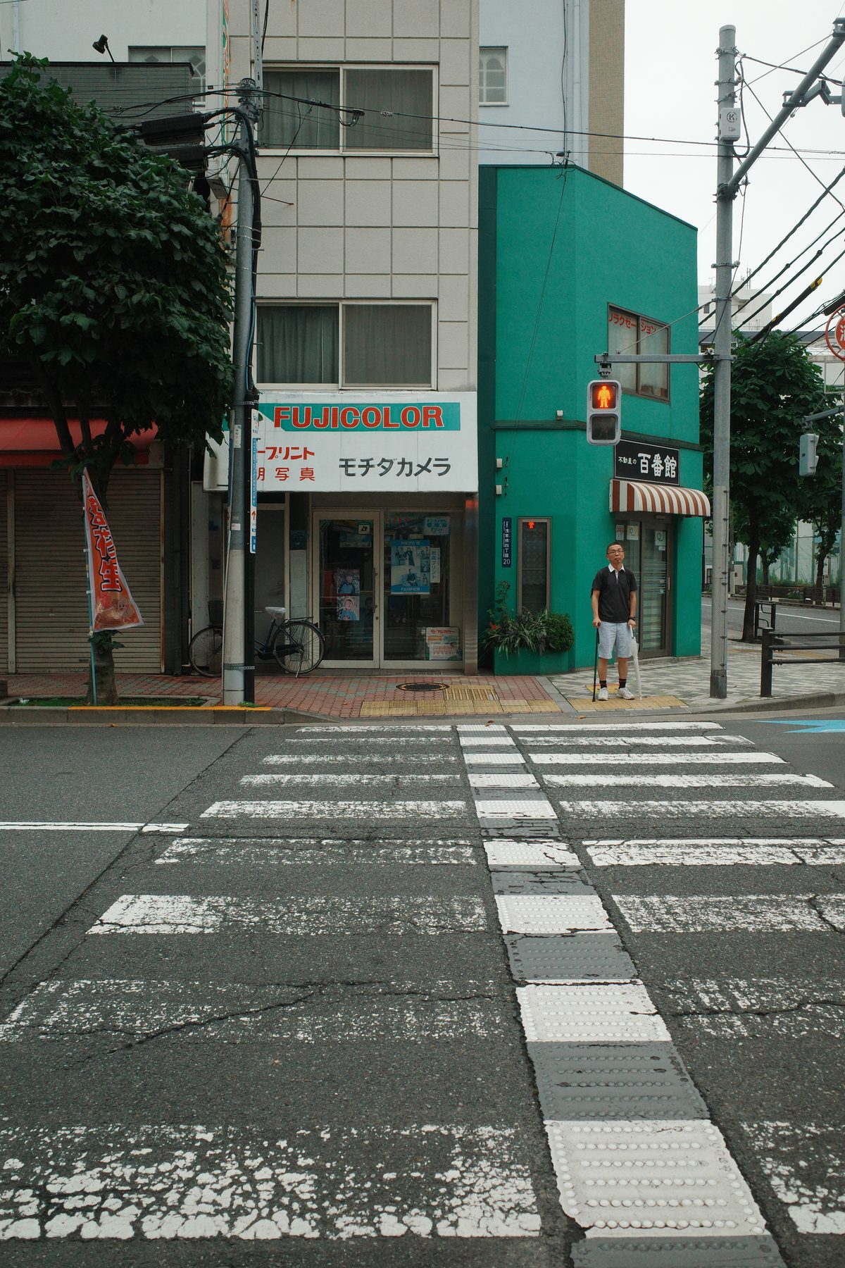 A green building at a crossing