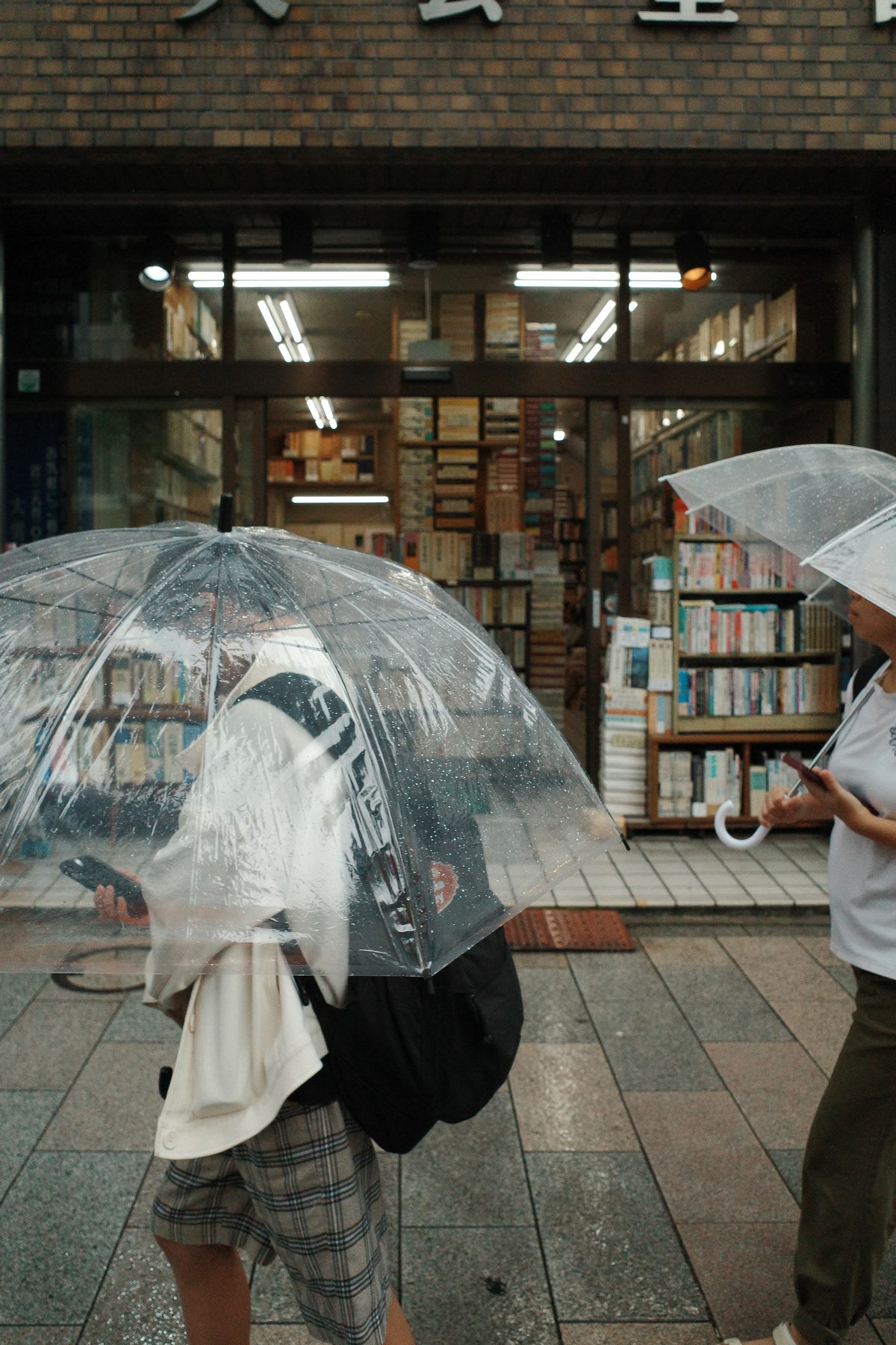 A man under a clear umbrella