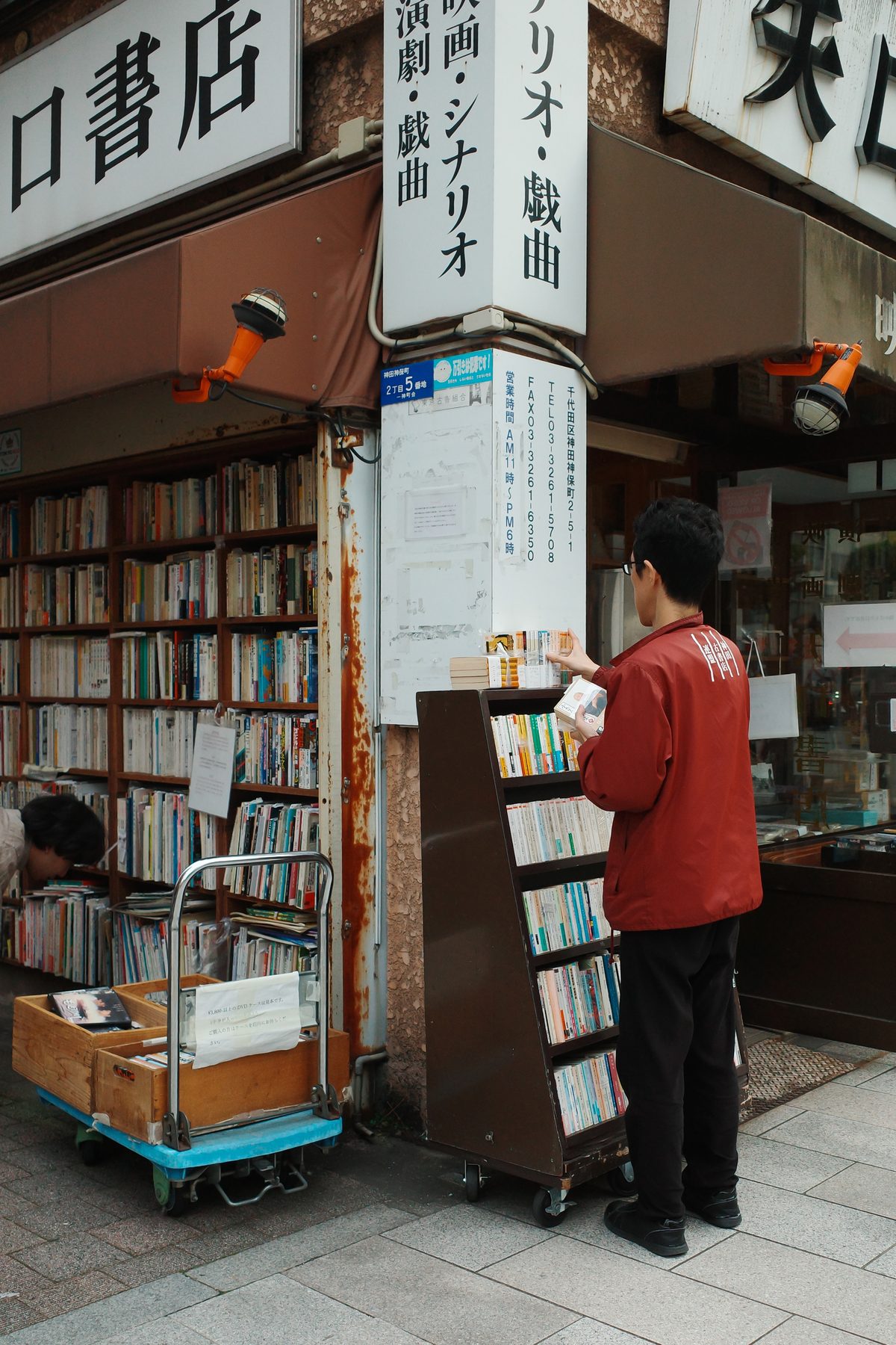 A bookseller in a red jacket