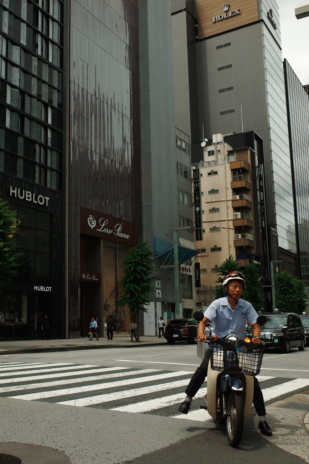 A man on a scooter in front of the towers
