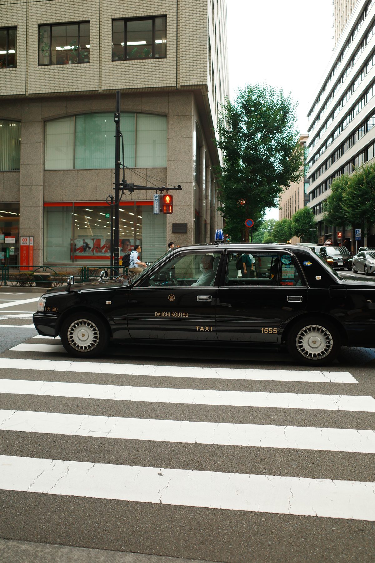 A black taxi at a crossing