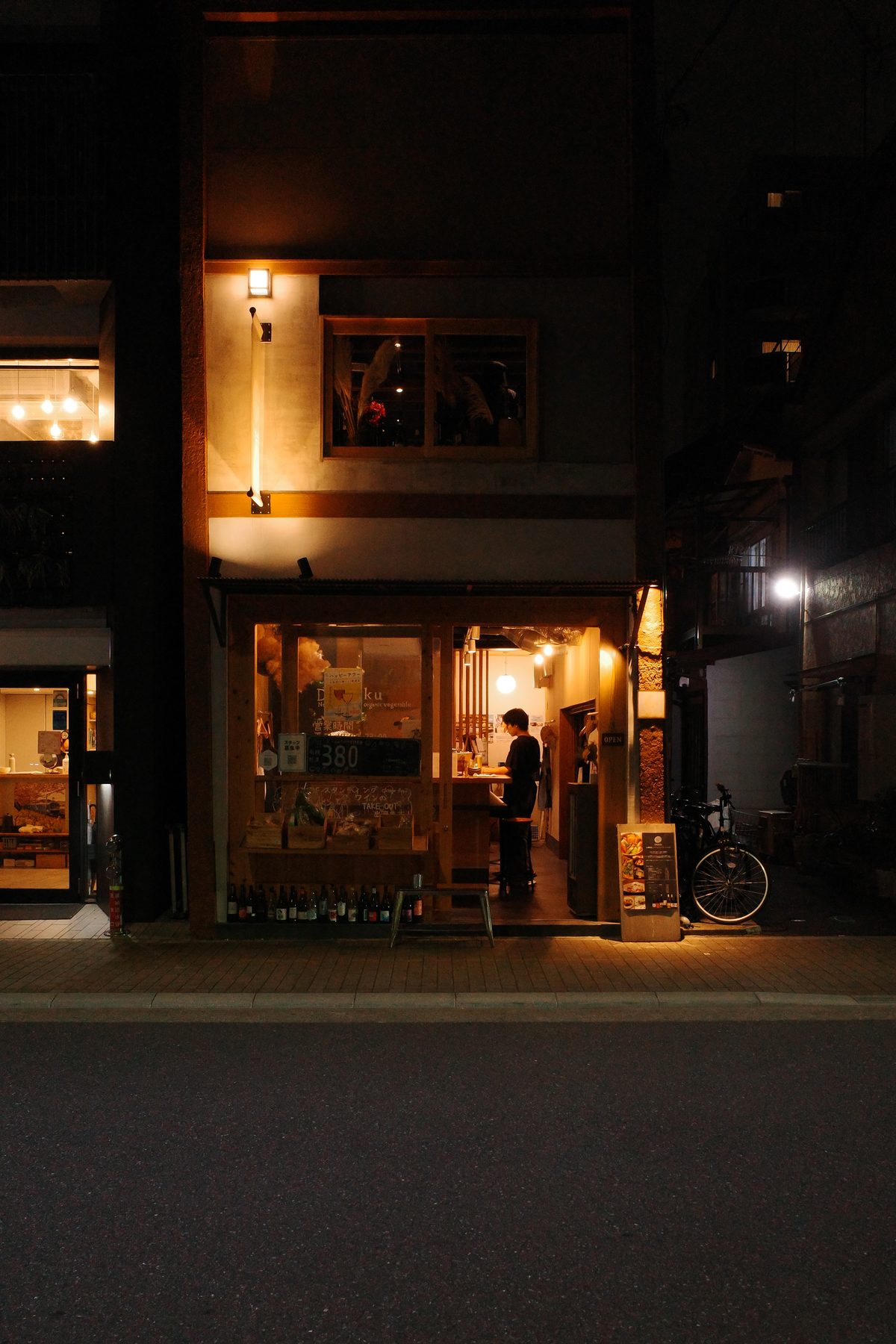 A small bar lit up at night