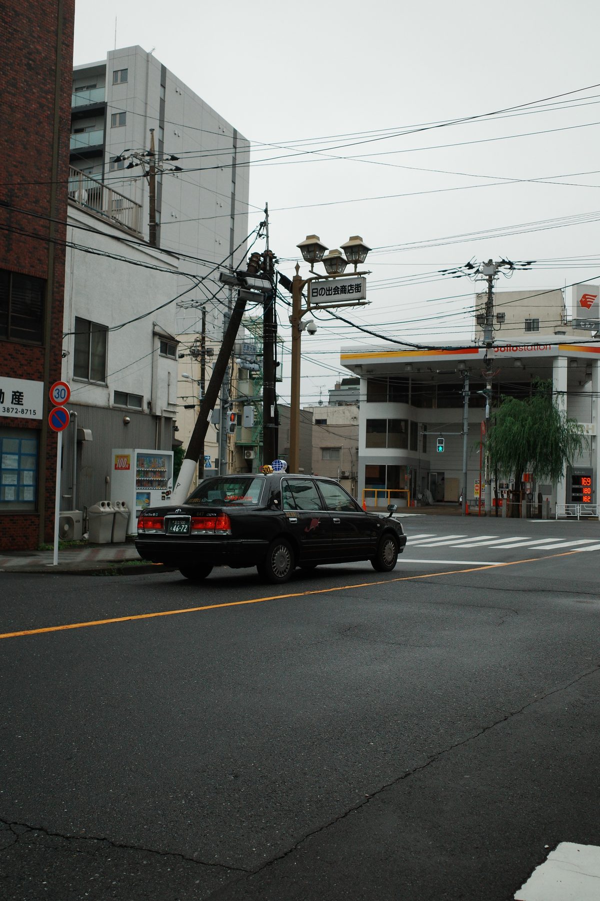 A black taxi at a crossroads