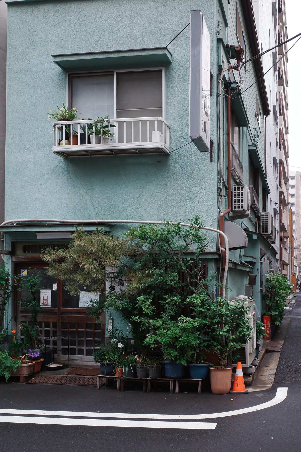 A green building with plants