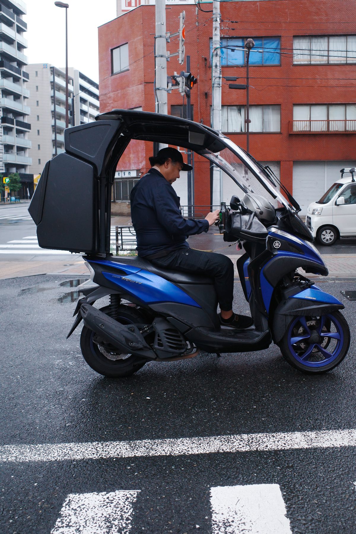 A covered scooter at a crossing