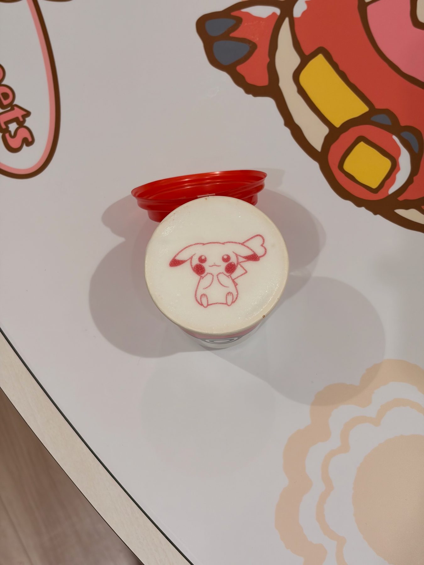 A drink with a Pokémon drawn on the foam