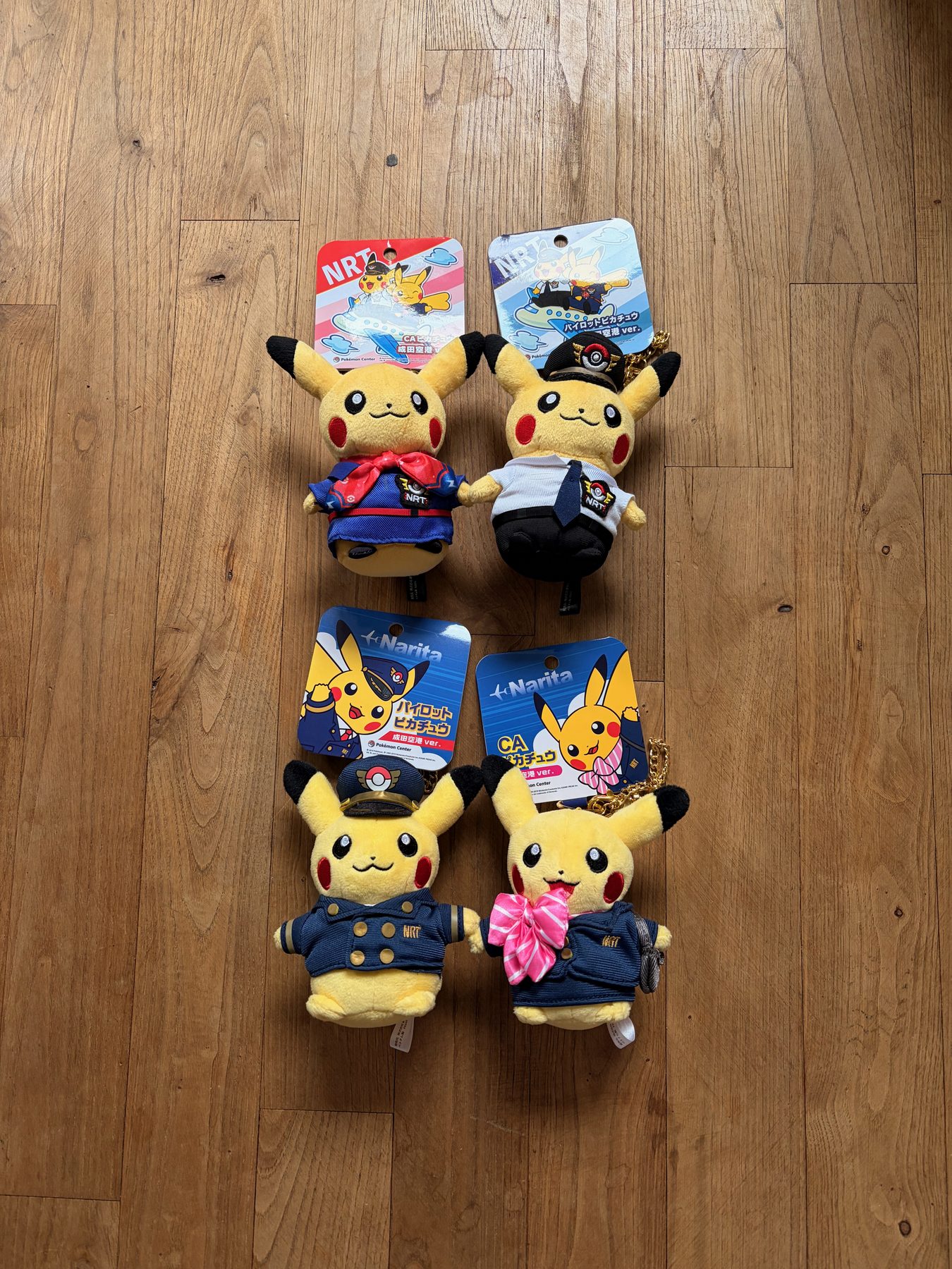 Four Pikachu plushes dressed as airline pilots