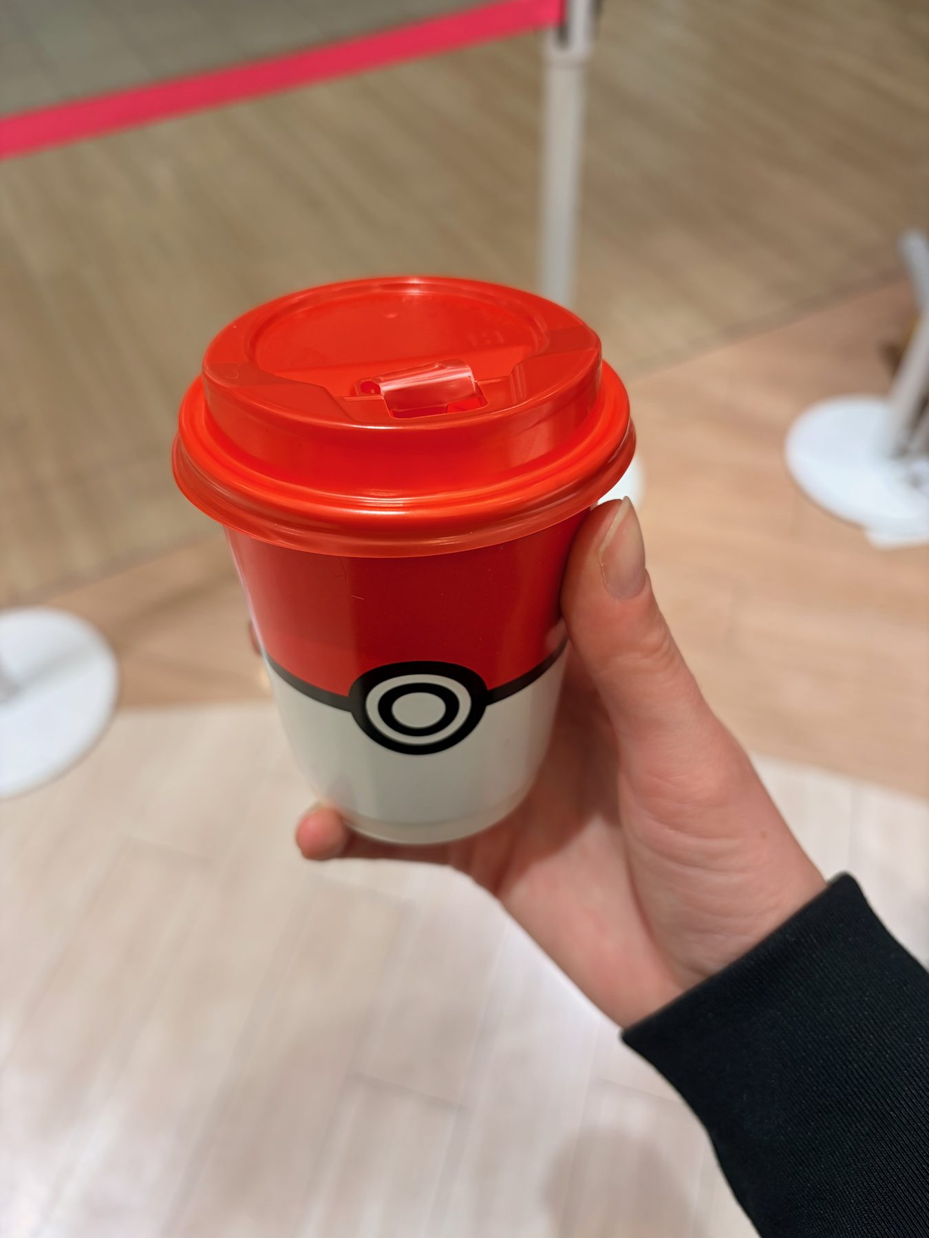 A Poké Ball coffee cup