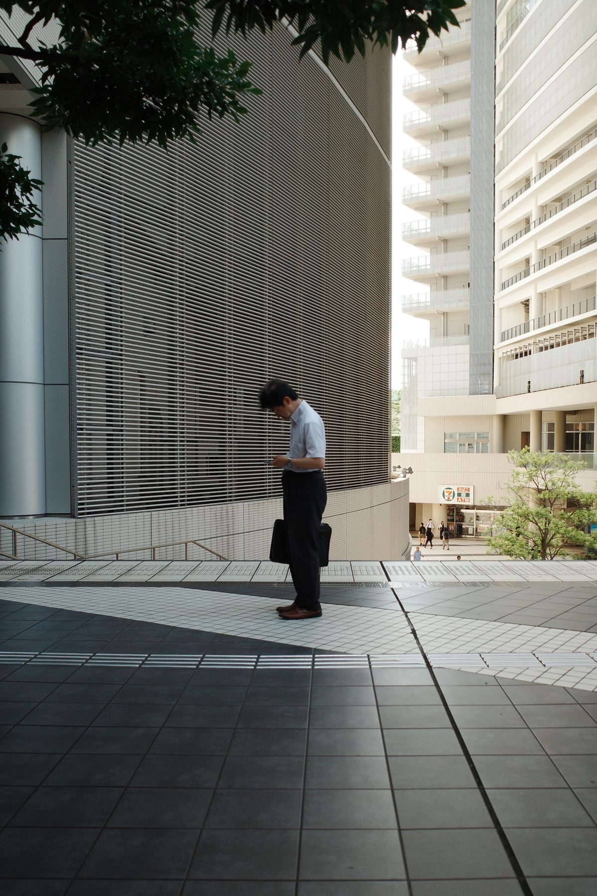 A man in a shirt by an office building