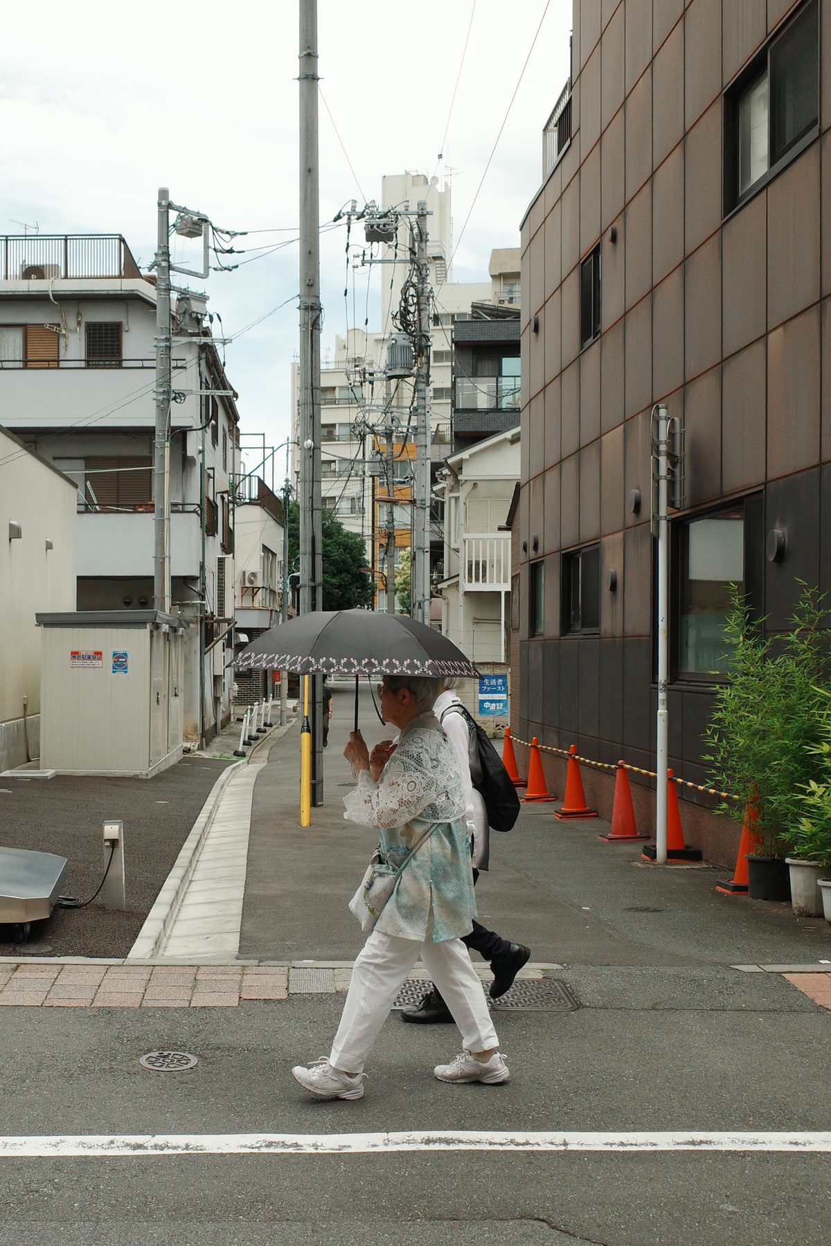 A woman walking under an umbrella