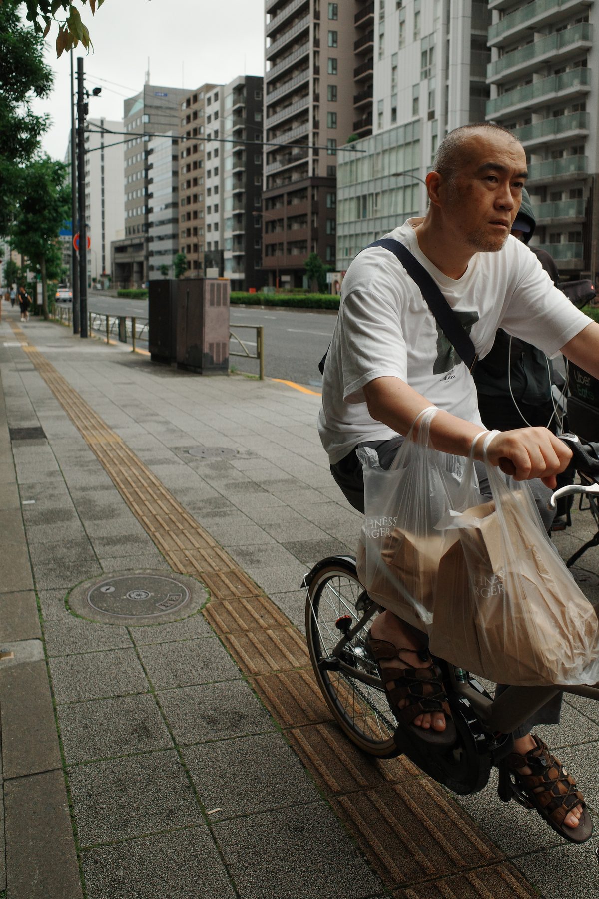 A man cycling with his shopping