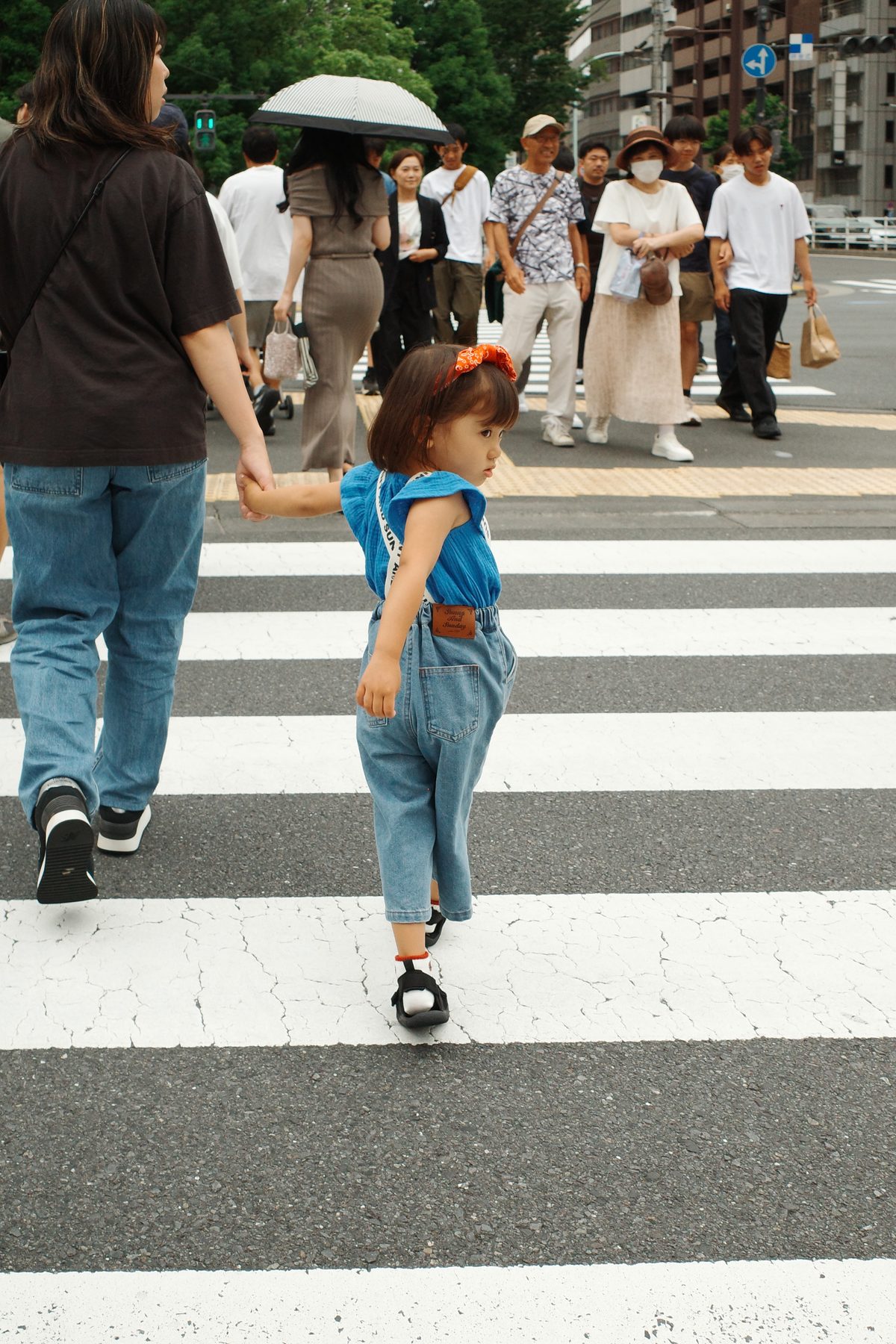 A little girl on a pedestrian crossing