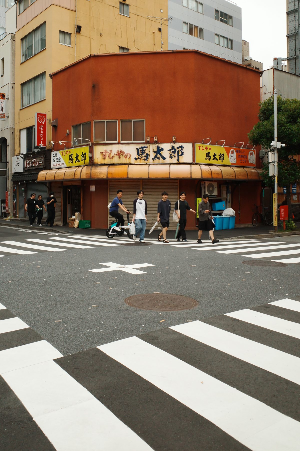 An orange building on a street corner in Gotanda