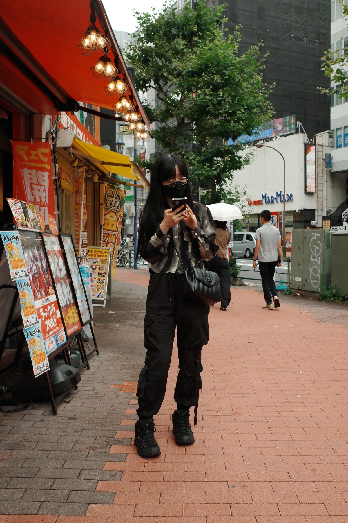 A woman under a red awning