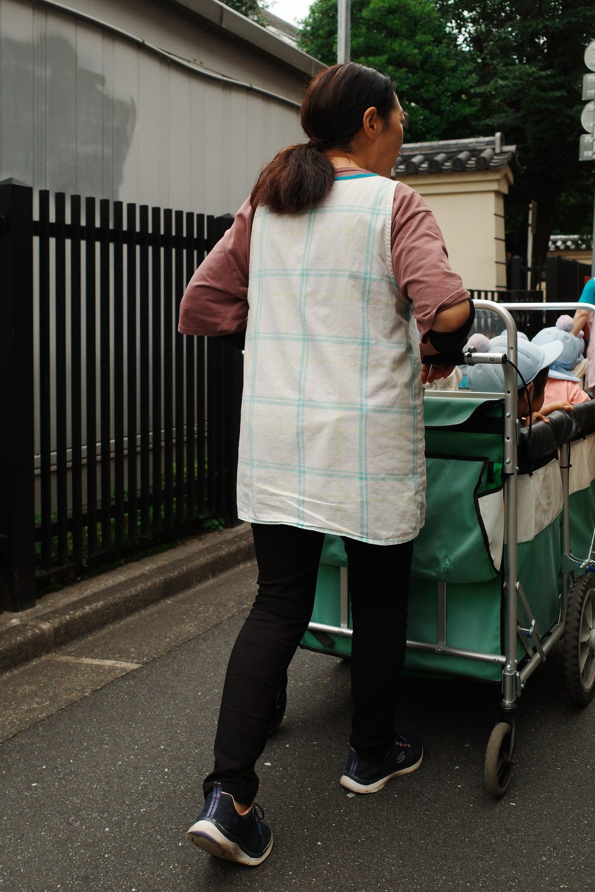 A nursery worker pushing a cart