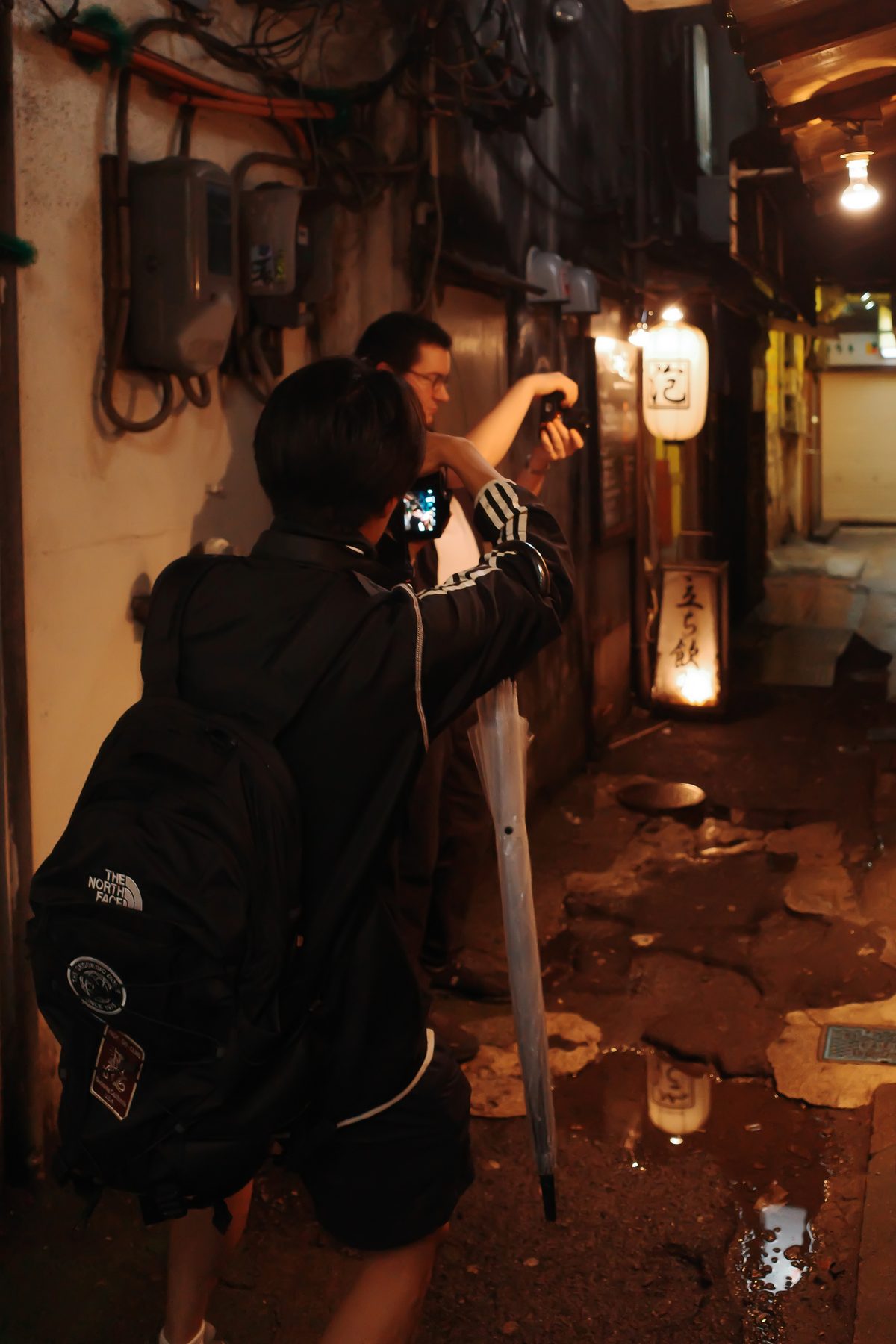 A photographer in an alley