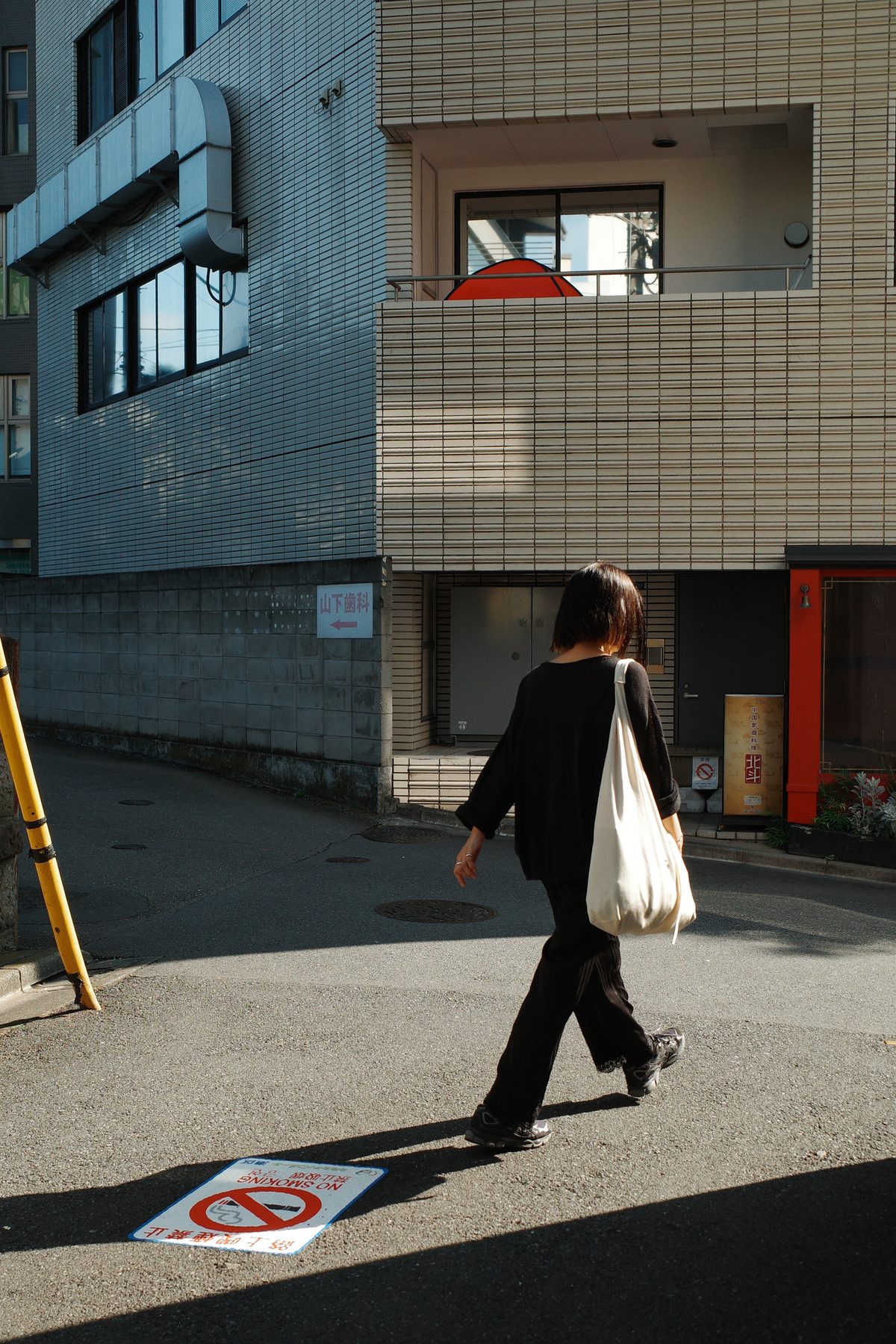 A woman walking in a back street of Omotesando
