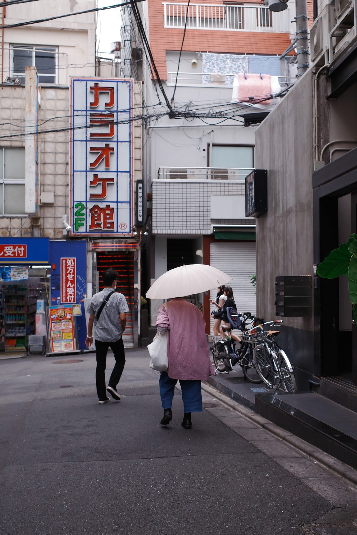 A woman with a parasol in Shimokitazawa
