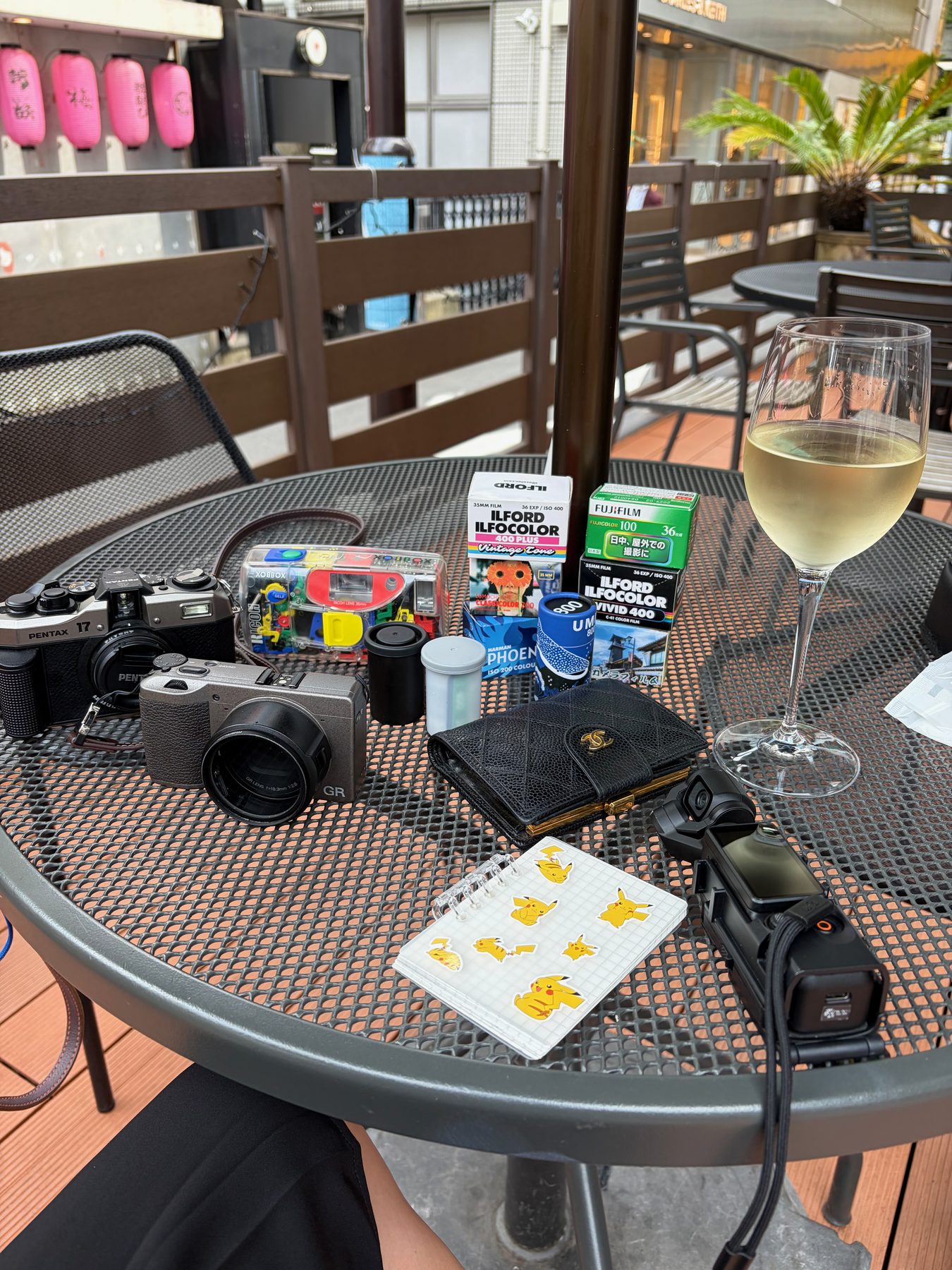 A glass of white wine and my cameras on a terrace